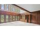 Spacious living room with wood paneling, built-in shelving, and abundant natural light at 1440 Northwold Dr, Atlanta, GA 30350