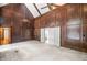 Elegant living room boasting wood paneling, vaulted ceilings, and ample natural light at 1440 Northwold Dr, Atlanta, GA 30350