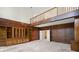 Large living room with wood paneling, built-in shelving, and access to a second floor loft at 1440 Northwold Dr, Atlanta, GA 30350