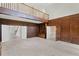 Large living room with a loft, wood paneling, built-ins, and multiple entrances at 1440 Northwold Dr, Atlanta, GA 30350