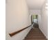 Carpeted staircase with a wooden handrail, leading to the upper or lower levels of the home at 1440 Northwold Dr, Atlanta, GA 30350