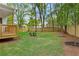 Lush backyard with a wooden fence, a small deck, and mature trees provides a private outdoor space at 1576 Hawthorne Se Ave, Smyrna, GA 30080