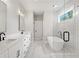 Luxurious bathroom features double sinks, a freestanding tub, and a glass-enclosed shower at 1576 Hawthorne Se Ave, Smyrna, GA 30080