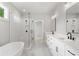 Elegant bathroom showcases double sinks, a freestanding tub, and a glass shower with modern fixtures at 1576 Hawthorne Se Ave, Smyrna, GA 30080