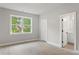 Bright bedroom with large window and doorway to a bathroom at 1576 Hawthorne Se Ave, Smyrna, GA 30080