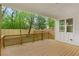 Covered deck with railing overlooking a green backyard, perfect for enjoying the outdoors in any weather at 1576 Hawthorne Se Ave, Smyrna, GA 30080