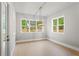 Bright dining room filled with natural light from multiple windows, and light colored hardwood flooring at 1576 Hawthorne Se Ave, Smyrna, GA 30080