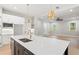 Spacious open concept kitchen with island, stainless appliances, white cabinets, and hardwood floors throughout at 1576 Hawthorne Se Ave, Smyrna, GA 30080