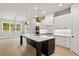 Spacious open concept kitchen with island, stainless appliances, white cabinets, hardwood floors and lots of natural light at 1576 Hawthorne Se Ave, Smyrna, GA 30080