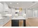 Beautiful kitchen featuring white cabinets, stainless steel appliances, gold fixtures and a dark island with white countertops at 1576 Hawthorne Se Ave, Smyrna, GA 30080