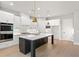 Beautiful kitchen featuring white cabinets, stainless steel appliances, gold fixtures and a dark island with white countertops at 1576 Hawthorne Se Ave, Smyrna, GA 30080