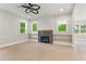 Bright living room features a modern ceiling fan and a cozy fireplace with light wood shelves at 1576 Hawthorne Se Ave, Smyrna, GA 30080