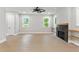 Bright living room features a modern ceiling fan and a cozy fireplace with light wood shelves at 1576 Hawthorne Se Ave, Smyrna, GA 30080