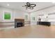 Spacious living room with hardwood floors, fireplace, and an open view of the kitchen at 1576 Hawthorne Se Ave, Smyrna, GA 30080