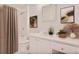 Bathroom with white vanity, shower and tub combination with white tiling and decorative artwork at 59 Saint Claire Ne Ln, Atlanta, GA 30324