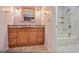 Bathroom featuring a wooden vanity with granite countertop and tiled shower/tub at 59 Saint Claire Ne Ln, Atlanta, GA 30324