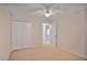 Carpeted bedroom with closet and ceiling fan at 59 Saint Claire Ne Ln, Atlanta, GA 30324