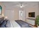 Cozy bedroom with a ceiling fan, large bed, white dresser and a view into the hallway at 59 Saint Claire Ne Ln, Atlanta, GA 30324
