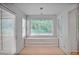 Bright dining area with a built-in cabinet and a large window showcasing the outdoor scenery at 59 Saint Claire Ne Ln, Atlanta, GA 30324