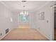 Dining room with neutral carpet, modern chandelier, and an open layout to the living area at 59 Saint Claire Ne Ln, Atlanta, GA 30324