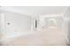 Spacious living room with neutral carpet, white walls, and an open layout to the dining area at 59 Saint Claire Ne Ln, Atlanta, GA 30324