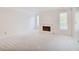 Bright living room featuring fireplace, neutral carpet, and plentiful natural light from windows at 59 Saint Claire Ne Ln, Atlanta, GA 30324