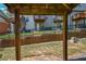 View of the backyard showing retaining wall, wrought iron fence, and townhouse decks at 2201 Landing Walk Dr, Duluth, GA 30097