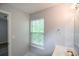Bathroom with a gold faucet, white sink, tile floors, and a window at 2201 Landing Walk Dr, Duluth, GA 30097