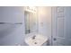 This bathroom features a sink and vanity, a mirror, and white trim and walls at 2201 Landing Walk Dr, Duluth, GA 30097