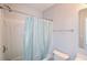 A full bathroom features a shower-tub combo with a curtain, a white toilet, and a mirror at 2201 Landing Walk Dr, Duluth, GA 30097