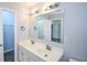 A bright bathroom features a double vanity, a large mirror, and a view to the bedroom at 2201 Landing Walk Dr, Duluth, GA 30097
