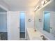 A bright bathroom features a double vanity, a large mirror, and a view to a walk-in closet and bedroom at 2201 Landing Walk Dr, Duluth, GA 30097