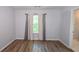 Bright bedroom with laminate flooring and a large window with curtains at 2201 Landing Walk Dr, Duluth, GA 30097