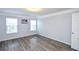 Bright bedroom with light gray walls, wood floor, and white trim at 2201 Landing Walk Dr, Duluth, GA 30097