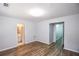 A bedroom has wood-look floors and two entryways including a door to an attached bathroom at 2201 Landing Walk Dr, Duluth, GA 30097