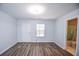 A bedroom with wood floors features access to a bathroom and a door to the home's exterior at 2201 Landing Walk Dr, Duluth, GA 30097