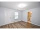 A light-filled bedroom features access to a bathroom and an exterior door, completed with wood floors at 2201 Landing Walk Dr, Duluth, GA 30097