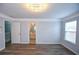 A bright bedroom features crown molding, a modern light fixture, and wood floors, with a view of the bathroom at 2201 Landing Walk Dr, Duluth, GA 30097
