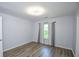 Bedroom with wood-look laminate flooring and light grey walls at 2201 Landing Walk Dr, Duluth, GA 30097