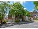 Brick townhome with a one-car garage, black shutters, and mature shade trees at 2201 Landing Walk Dr, Duluth, GA 30097