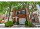 Charming brick townhome featuring black shutters, mature landscaping, and a convenient one-car garage at 2201 Landing Walk Dr, Duluth, GA 30097