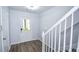 Entryway with sleek floors and white staircase, combining contemporary style and functional home design at 2201 Landing Walk Dr, Duluth, GA 30097