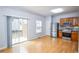 Open kitchen with stainless steel appliances, wood cabinets, hardwood floors, and sliding glass door access at 2201 Landing Walk Dr, Duluth, GA 30097