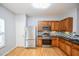 Stainless steel appliances, wood cabinets, tile backsplash in a modern kitchen at 2201 Landing Walk Dr, Duluth, GA 30097