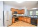 An open kitchen boasts stainless steel appliances and lovely countertops with wood finish cabinetry at 2201 Landing Walk Dr, Duluth, GA 30097