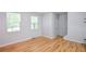 Bright living space features hardwood floors, windows, and neutral paint at 2201 Landing Walk Dr, Duluth, GA 30097