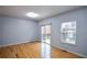Bright living room with wood floors, slider door leading to deck, and an adjacent window at 2201 Landing Walk Dr, Duluth, GA 30097