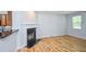 Cozy living space featuring a classic fireplace and gleaming hardwood flooring at 2201 Landing Walk Dr, Duluth, GA 30097