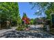 A beautifully landscaped entrance features stone pillars, black iron gates, and mature trees at 2201 Landing Walk Dr, Duluth, GA 30097