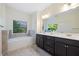 Bright bathroom features double vanity with modern cabinets, soaking tub, and natural light at 3231 Chutney Ct, Avondale Estates, GA 30002